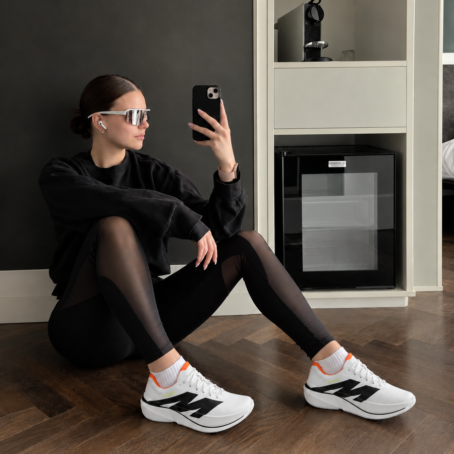 Woman seated on the floor at home in AURORO MOVE shoes