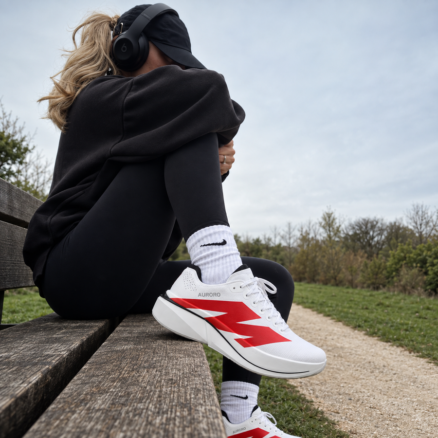 Woman resting on a park bench in AURORO MOVE shoes
