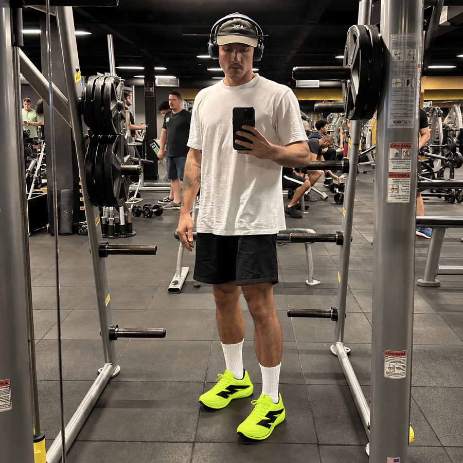 Man in a gym wearing AURORO MOVE shoes