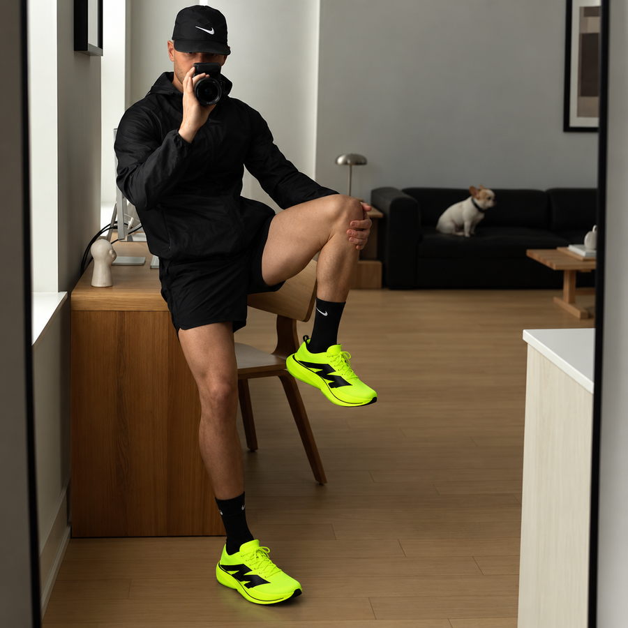 Man stretching in a living room in AURORO MOVE shoes